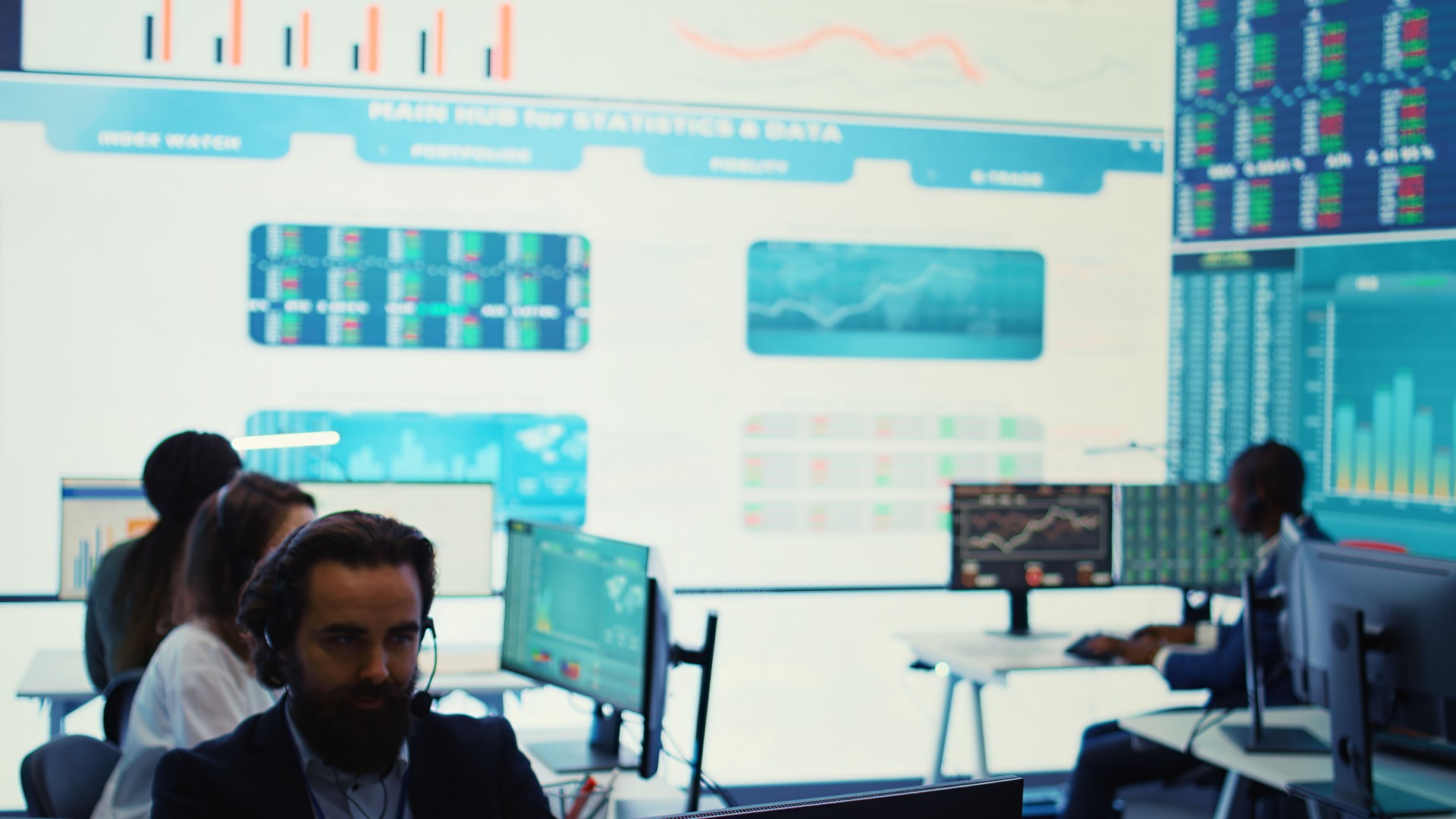 Team of forecast affiliates examining annual infographics on a big data screen